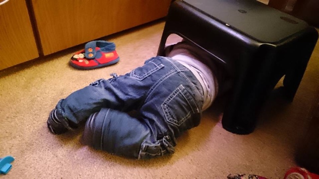 Baby climbing under a stool Baby climbing under a stool