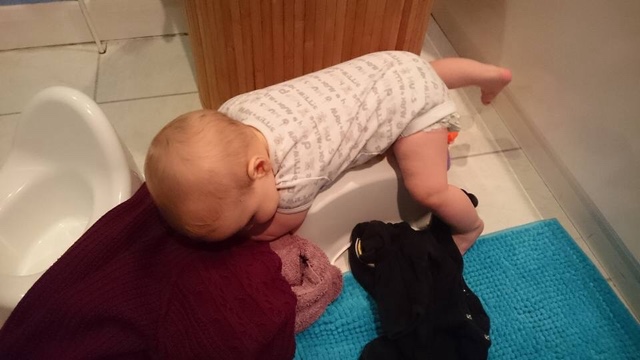 Baby climbing over a stool Baby climbing over a stool