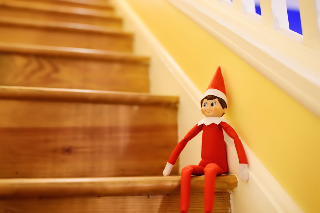 Funny Christmas toy elf on stairs