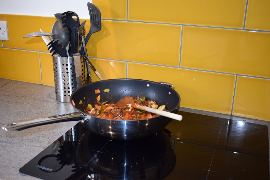 Induction hob cooking bolognese