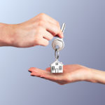 passing keys with trinket against on blue background